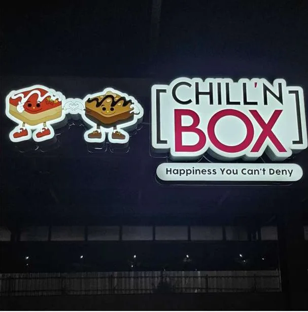 Chill'n Box lit sign on a dark facade