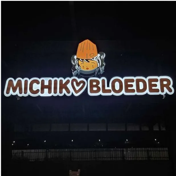 Michiko Bloeder lit sign with mascot