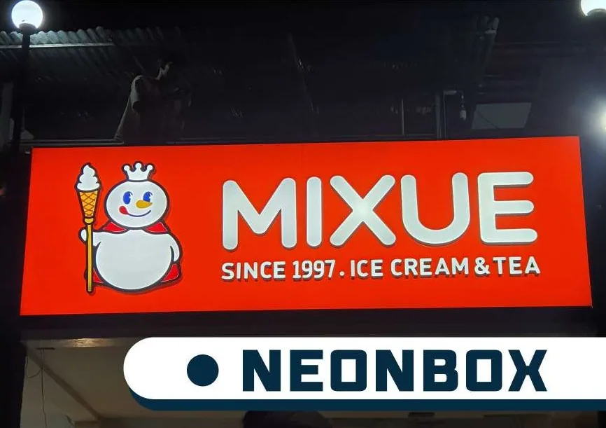 Mixue lit sign box above a shopfront at night