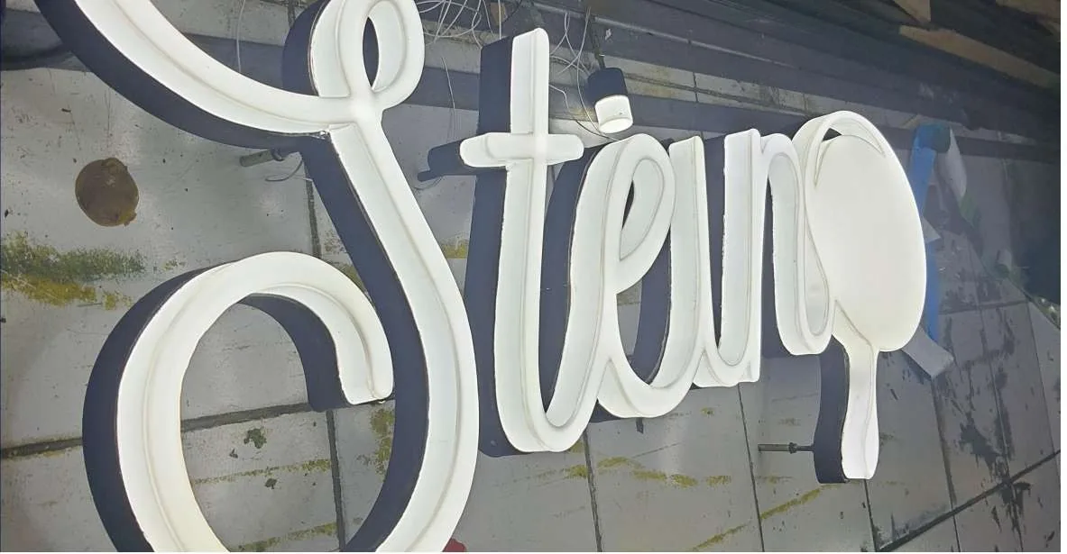 Stew white dimensional script letters in the workshop